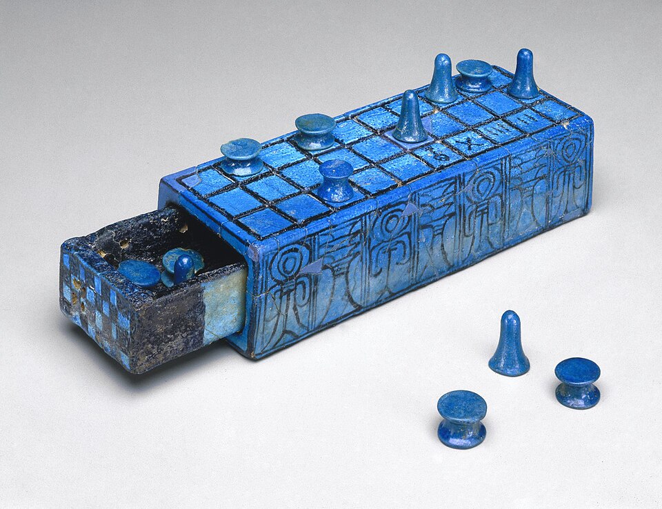 An ancient Egyptian Senet board with playing pieces.