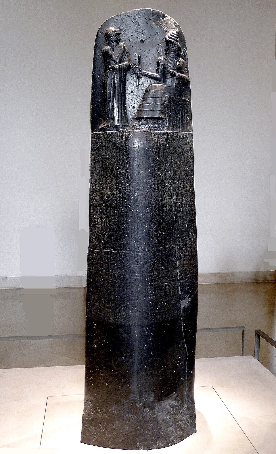 The basalt stele of the Code of Hammurabi, showing the king receiving the law from the god Shamash.