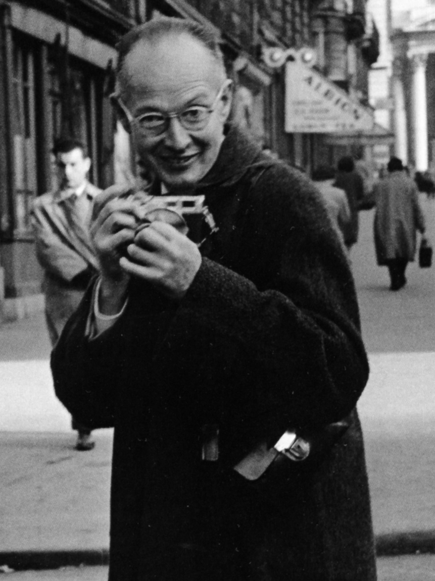 Henri Cartier-Bresson, co-founder of Magnum Photos, with his Leica.