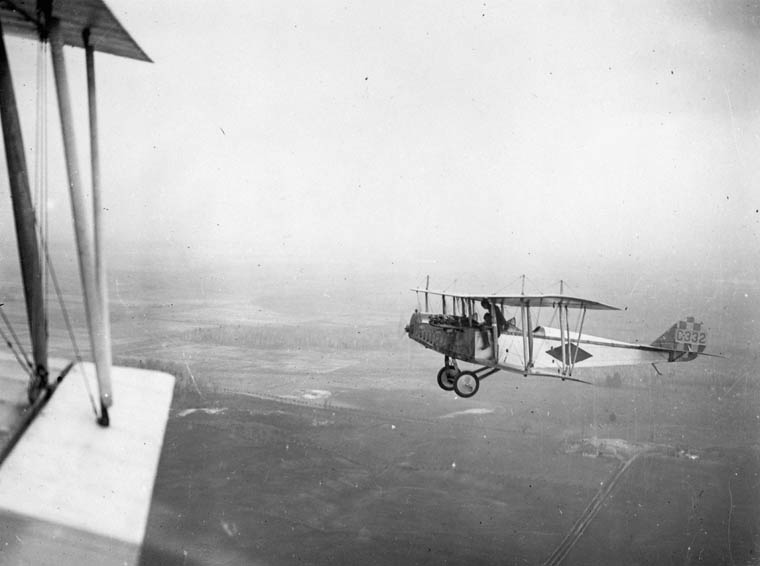 A barnstorming biplane performing at an air show in the 1920s.