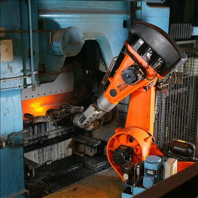 Industrial robot arms welding car bodies on an automotive assembly line